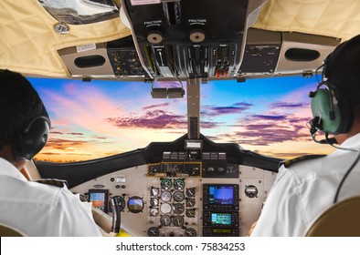 Pilots In The Plane Cockpit And Sunset