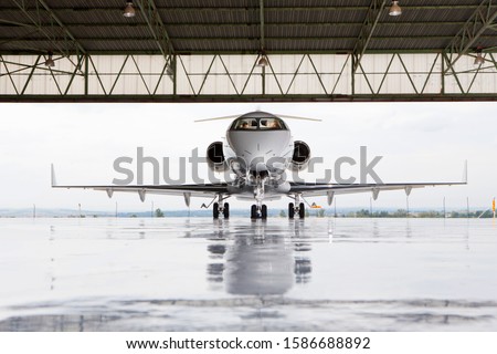 Pilots in private jet in hangar Imagine de stoc © 