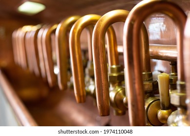 Pilsen, Czech Republic, 1.09.2019 - vintage copper taps at beer brewery, interior of Pilsner Urquell Museum. Beer background. Retro style. Beer brewing traditions. 19th century brewing equipment