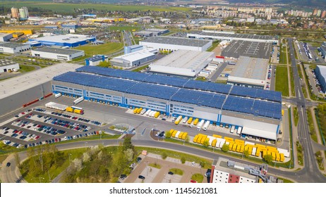 PILSEN, CZECH REPUBLIC - APRIL 19, 2018: Flight Over Modern Storage Warehouse With Solar Panels On The Roof. Industrial Zone And Technology Park On Bory Suburb Of Pilsen City, Czech Republic, Europe.