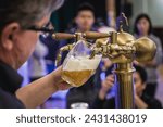 Pilsen, Czech Republic - October 2, 2015: Man pouring beer called Mliko in Pilsen city