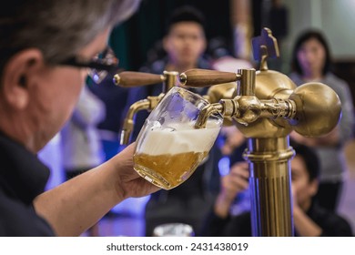 Pilsen, Czech Republic - October 2, 2015: Man pouring beer called Mliko in Pilsen city - Powered by Shutterstock