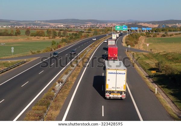 PILSEN, CZECH REPUBLIC - OCTOBER 2,\
2015: Line of trucks on the D5 highway. The D5 is important\
transport connection between West Bohemia and Bavaria in\
Germany.