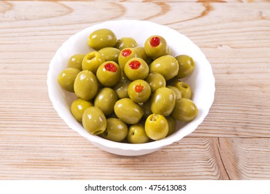 pimento stuffed olives on wooden background - Powered by Shutterstock