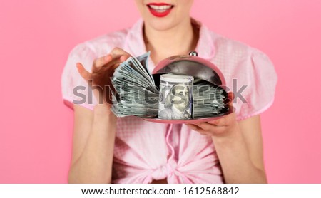 Pin up girl with dollar banknotes. Close-up portrait of woman with dollar banknotes on serving tray. Banknotes. Credit. Taxes. Money. Cash. Necessary. People savings. Loan payment.