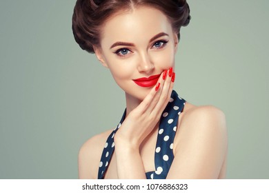 Pin Up Girl Vintage. Beautiful Woman Pinup Style Portrait In Retro Dress And Makeup, Manicure Nails Hands, Red Lipstick And Polka Dot Dress. Studio Shot.