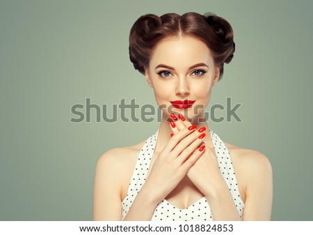 Pin up girl vintage. Beautiful woman pinup style portrait in retro dress and makeup, manicure nails hands, red lipstick and polka dot dress.