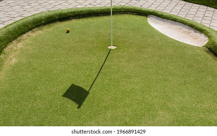 Pin, Hole And Ball Of A Minigolf Course.