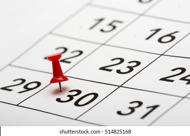 Pin on the date number 30. The thirtieth day of the month is marked with a red thumbtack. Last days of month Focus point on the red pin.