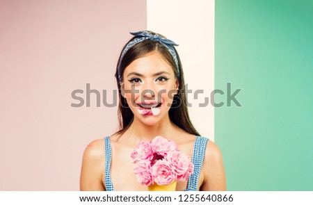 pin up woman with trendy makeup. retro woman eating ice cream from flowers. pinup girl with fashion hair. pretty girl in vintage style. flower bouquet. Florist. Summer. Time for fun.