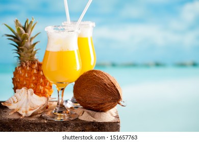 Pina Colada Cocktail On Blue Beach Background