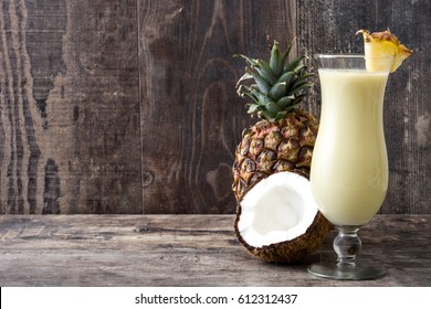 Pina colada cocktail on wooden background.
