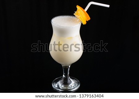 Pina Colada Cocktail - sweet cocktail made with rum, coconut cream or coconut milk garnished with pineapple wedge, selective focus