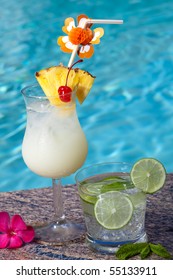 Pina Colada And Mojito Cocktails On Swimming Pool Side