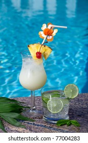 Pina Colada And Mojito Cocktails On Swimming Pool Side