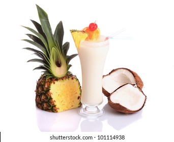 Pina Colada over white background, garnished with slice of pineapple and coconut.