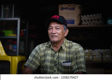 Pinangah, Sabah / Malaysia - March 09 2018: A Portrait Of Man Sitting On The Stair Of His House At Kampung Karamuak