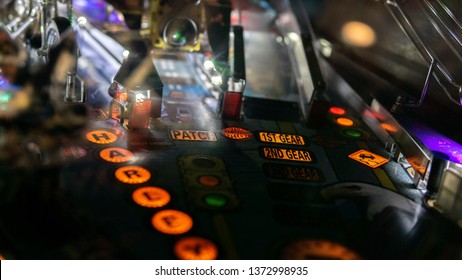 Pinball machine in a dark room - Shutterstock ID 1372998935