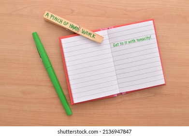 A Pinch of Hard Work clothes pin attached to open notebook with message Get To It with Tenacity