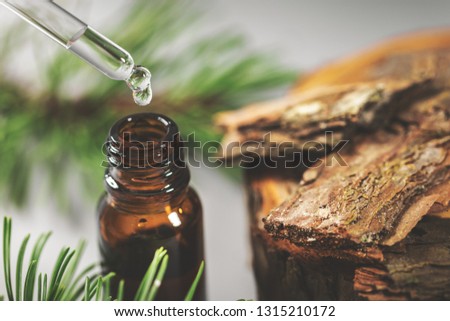 pine bark tincture dripping from glass pipette