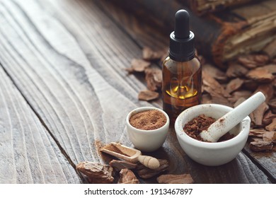 Pine Bark, Tincture Or Oil Bottle, Mortars Of Powdered Pine Bark And Old Books On Background. Copy Space For Text.