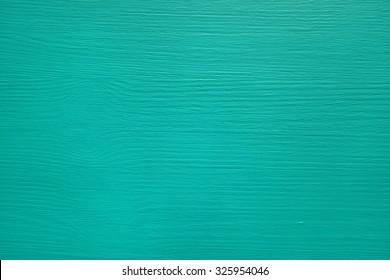 Pine board painted teal, wood grain texture showing through