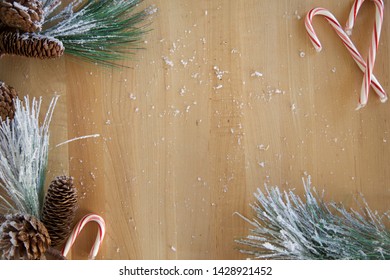 Pine Boughs & Candy Canes On A Cutting Board (flat Lay Image)