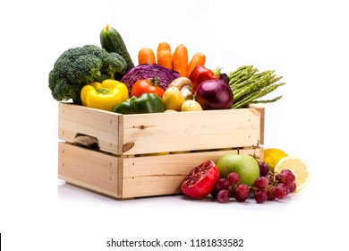 Pine box full of colorful fresh vegetables and fruits on a white background, ideal for a balanced diet, contains broccoli, cucumber, onion, asparagus, peppers, carrots, apple, grape, lima and potatoes - Shutterstock ID 1181833582