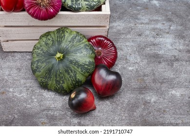 Pine Box Full Of Colorful Fresh Vegetables On A Table And Gray Background. Beautiful Irregular Shaped Vegetables. Food Waste From Supermarket. Trendy Vegetables Concept. Selective Focus