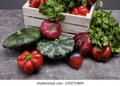 Pine Box Full Of Colorful Fresh Vegetables On A Table And Gray Background. Beautiful Irregular Shaped Vegetables. Food Waste From Supermarket. Trendy Vegetables Concept. Selective Focus