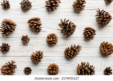 pine cones on colored table. natural holiday background with pinecones grouped together. Flat lay. Winter concept. - Shutterstock ID 2174935127