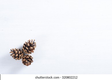 Pine Cones On White Wood Table, Purity Christmas Decoration