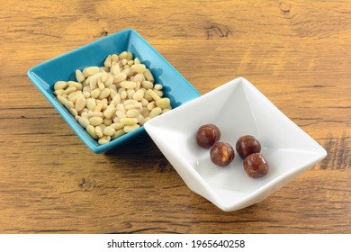 Pine Nut Hard Candy In White Candy Dish With Pine Nuts In Blue Snack Dish