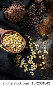 Pine nuts on stone table. Black background. Top view