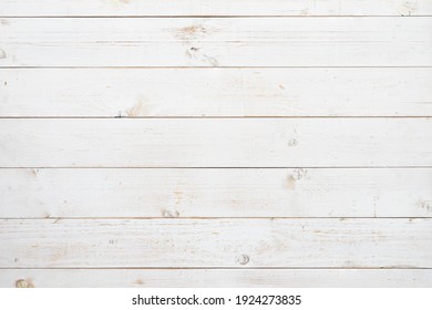 Pine wood plank texture painted with white color in horizontal rows for use as wood pattern, background, backdrop, table top, wall plank, floor plank, etc.
