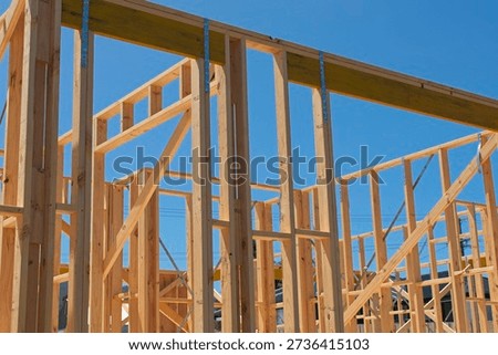 Pine wood stud wall frames on a house under construction in Australia; a symbol of the housing property crisis.