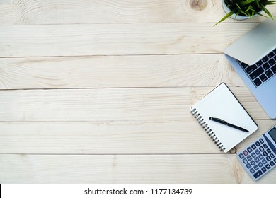  Pine Wooden Of Desk Table With Workspace And Empty Blank Notebook,computer Laptop,calculator,pen,flower Pot.Top View Of Tools For Work Office,flat Lay.Copy Space For Text.                            