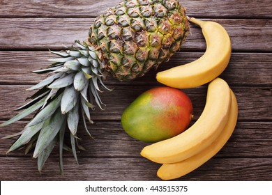 Pineapple Banana Mango On Wooden Background Stock Photo (Edit Now) 443515375