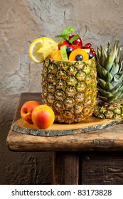 Pineapple filled with colorful assorted fruit salad