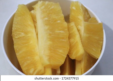 Pineapple Flesh Slices In Long Pieces Put In White Bowl.