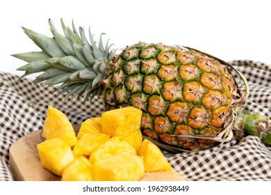 Pineapple And Fresh Sliced Pineapple On Wooden Tray On Table Cloth.