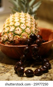 Pineapple With A Kukui Nut Lei In A Bowl