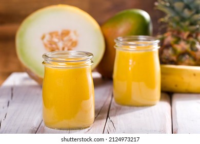 Pineapple And Mango Melon Shake On White Wood