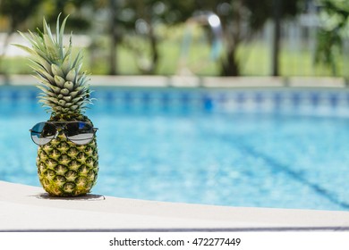 A pineapple relaxing by the pool