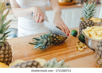 Pineapple Sliced By A Girl On The Kitchen Counter. Pineapples Contain A Group Of Digestive Enzymes As Bromelain, Function As Proteases, Break Down Protein Molecules Into Amino Acids And Small Peptides