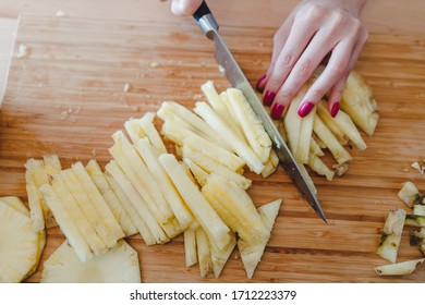 Pineapple Sliced By A Girl On The Kitchen Counter. Pineapples Contain A Group Of Digestive Enzymes As Bromelain, Function As Proteases, Break Down Protein Molecules Into Amino Acids And Small Peptides