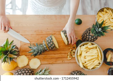 Pineapple Sliced By A Girl On The Kitchen Counter. Pineapples Contain A Group Of Digestive Enzymes As Bromelain, Function As Proteases, Break Down Protein Molecules Into Amino Acids And Small Peptides