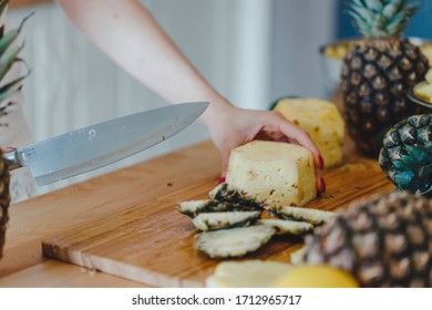 Pineapple Sliced By A Girl On The Kitchen Counter. Pineapples Contain A Group Of Digestive Enzymes As Bromelain, Function As Proteases, Break Down Protein Molecules Into Amino Acids And Small Peptides