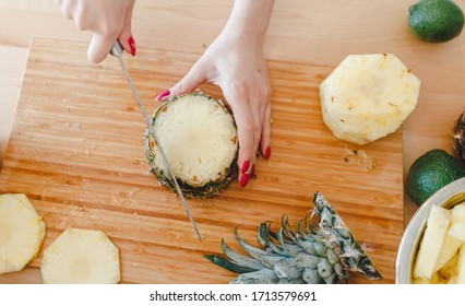 Pineapple Sliced By A Girl On The Kitchen Counter. Pineapples Contain A Group Of Digestive Enzymes As Bromelain, Function As Proteases, Break Down Protein Molecules Into Amino Acids And Small Peptides