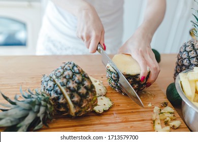 Pineapple Sliced By A Girl On The Kitchen Counter. Pineapples Contain A Group Of Digestive Enzymes As Bromelain, Function As Proteases, Break Down Protein Molecules Into Amino Acids And Small Peptides